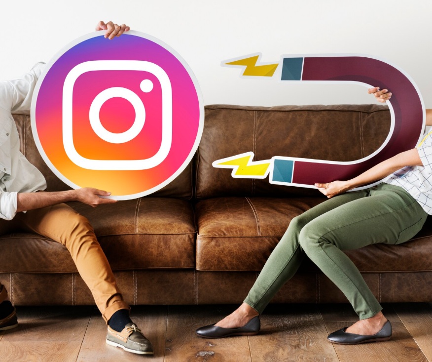 Concept picture of a couple holding an Instagram icon and a magnet one