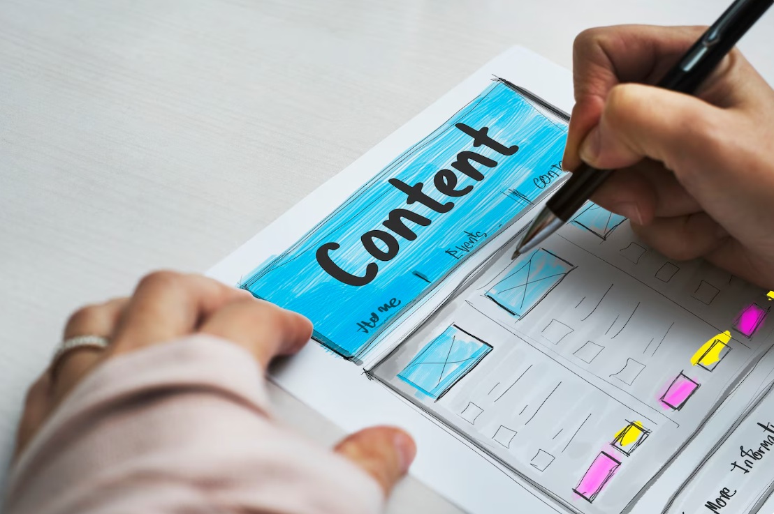 Focus on designer hand drawing a web wireframe