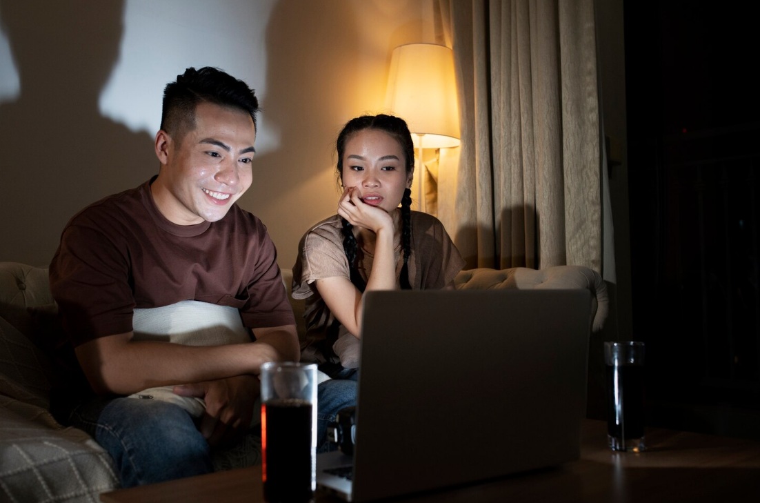 8 Steps to Build a Video Marketing Strategy (+ 6 Extra Tips) 4 Young Asian couple watching a video on laptop