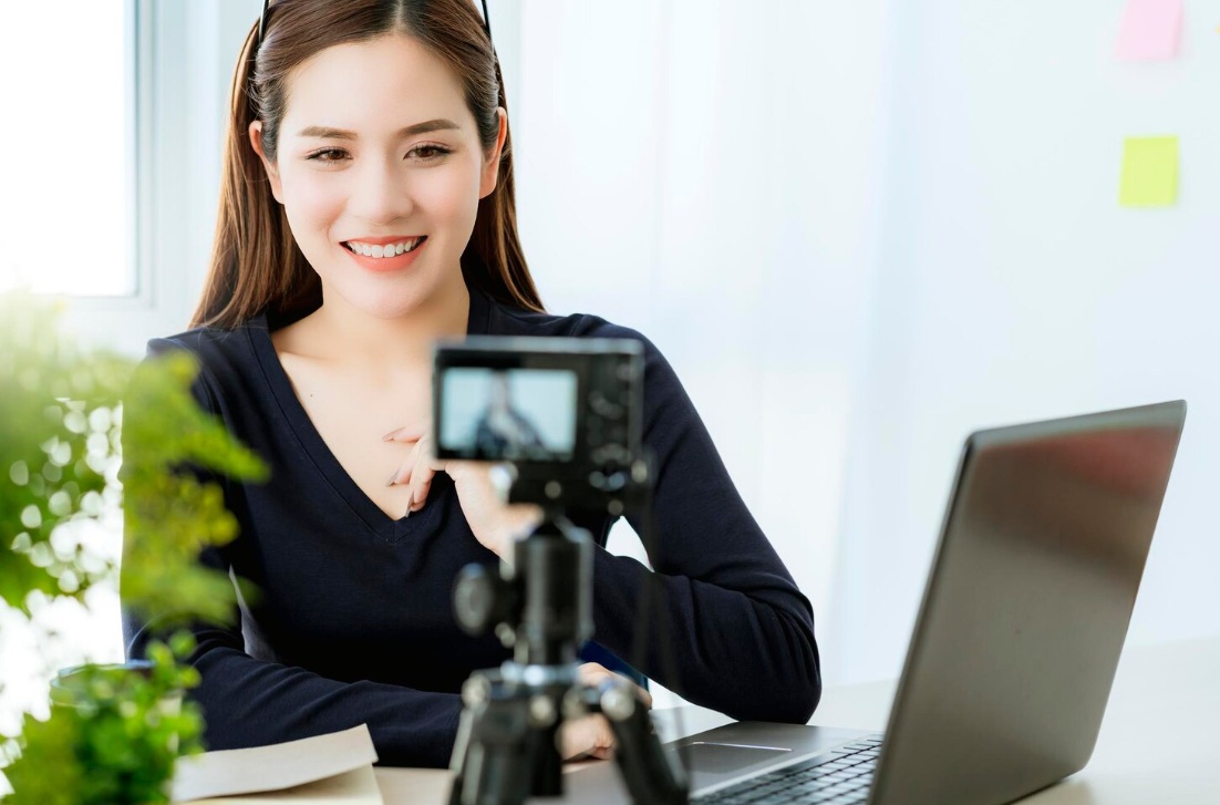 Young Asian woman recording a video on her camera