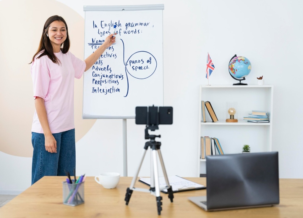 8 Steps to Build a Video Marketing Strategy (+ 6 Extra Tips) 3 Young woman teaching English on video