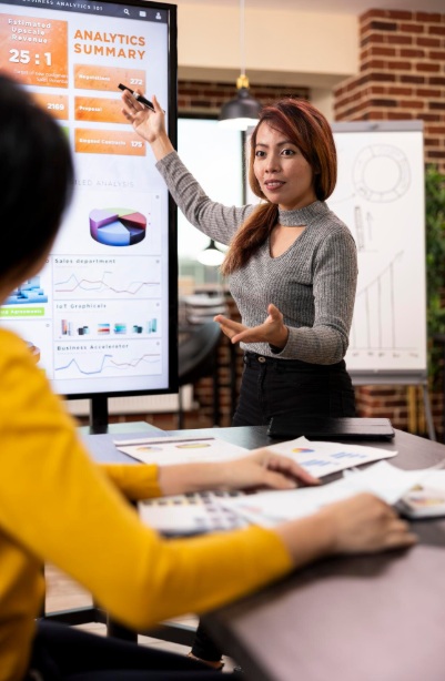 Businesswoman presenting analytics data on screen