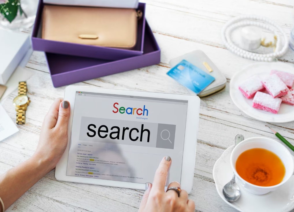 Woman pointing at a search result page displayed on her tablet