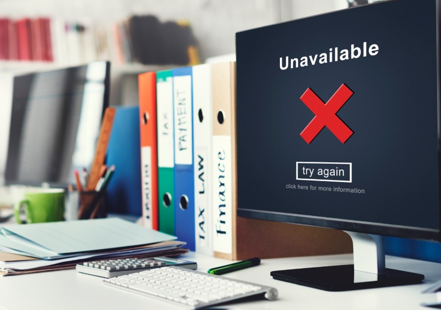 Negative Content Removal 2 Office desk with laptop displaying unavailable error notification