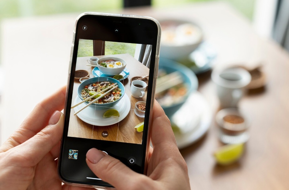 Smartphone taking a picture of an Asian meal