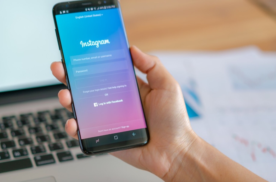 hand holding a smartphone showing the Instagram login screen